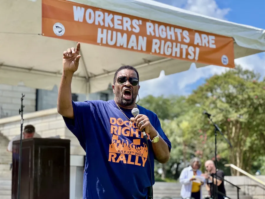 Rep. Wendell Gilliard speaks at ILA Rally in Columbia, S.C. under a banner reading "Worker's Rights Are Human Rights!"