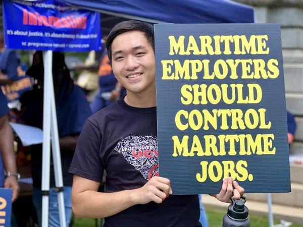 UCW SC Member holds sign in support of ILA