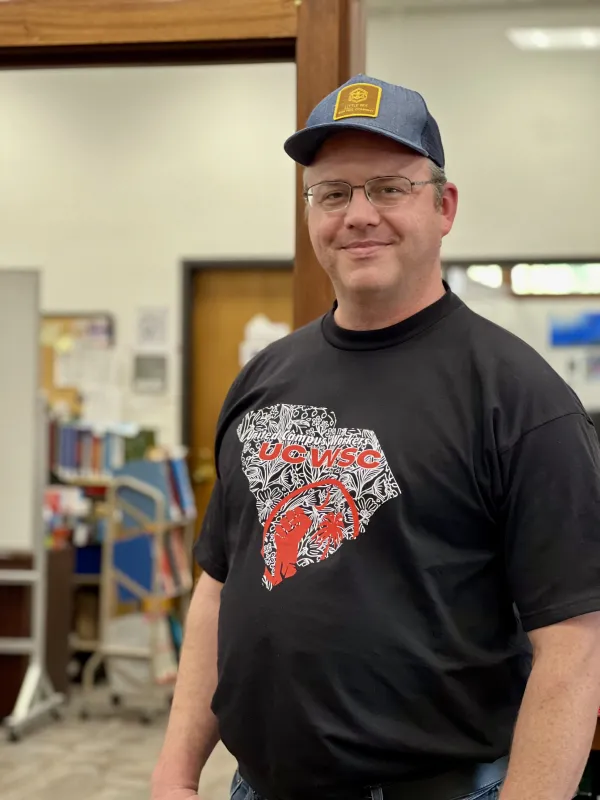 Union member Timothy shows off his union shirt